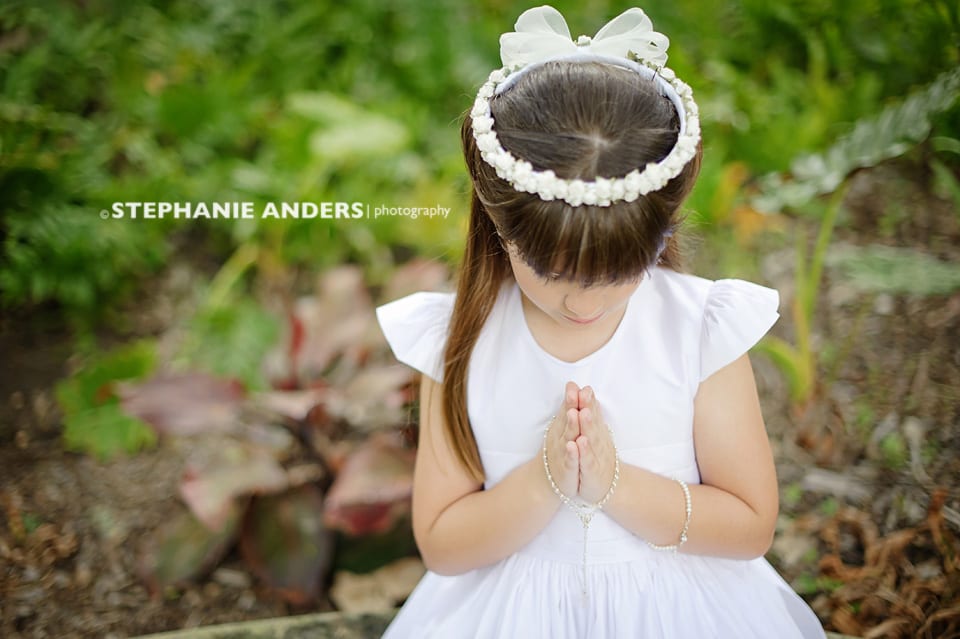 small child praying with cute white dress and headband
