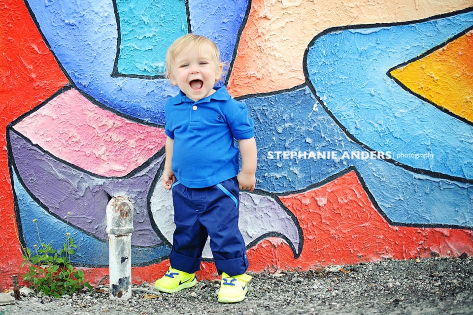 colorful background with baby boy excited