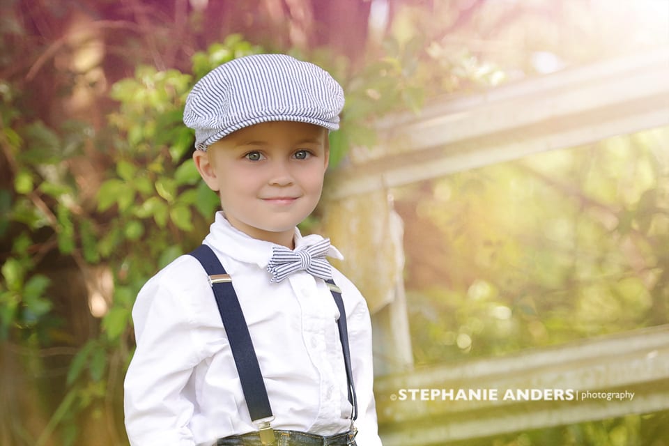 cute boy with bow tie and cap