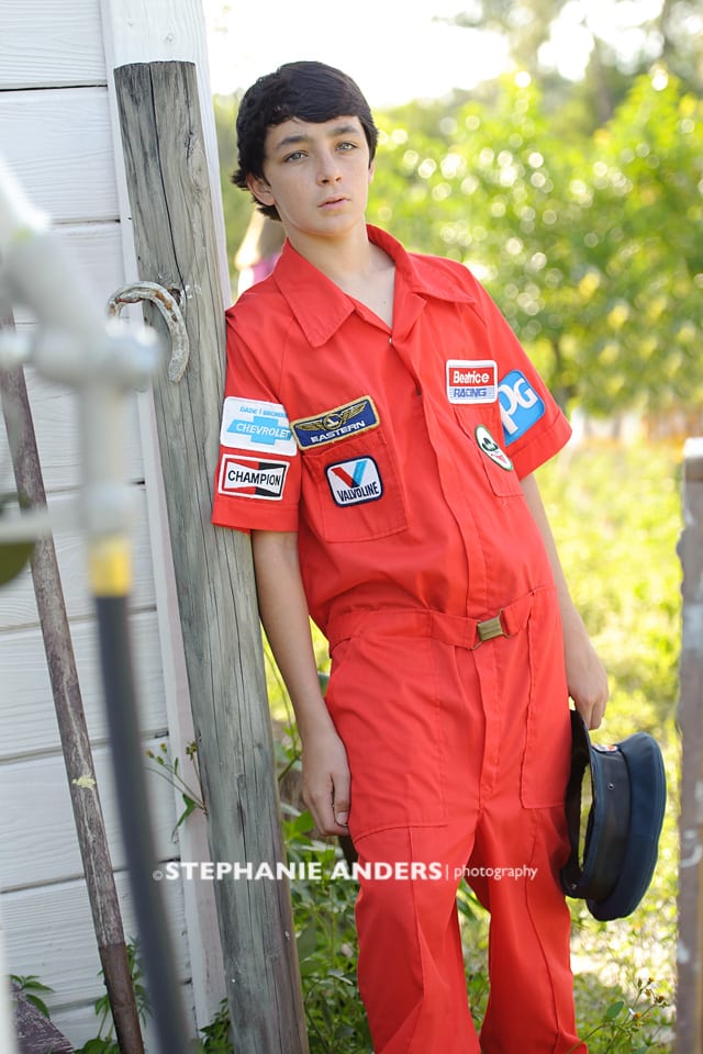 young man with orange racing overalls
