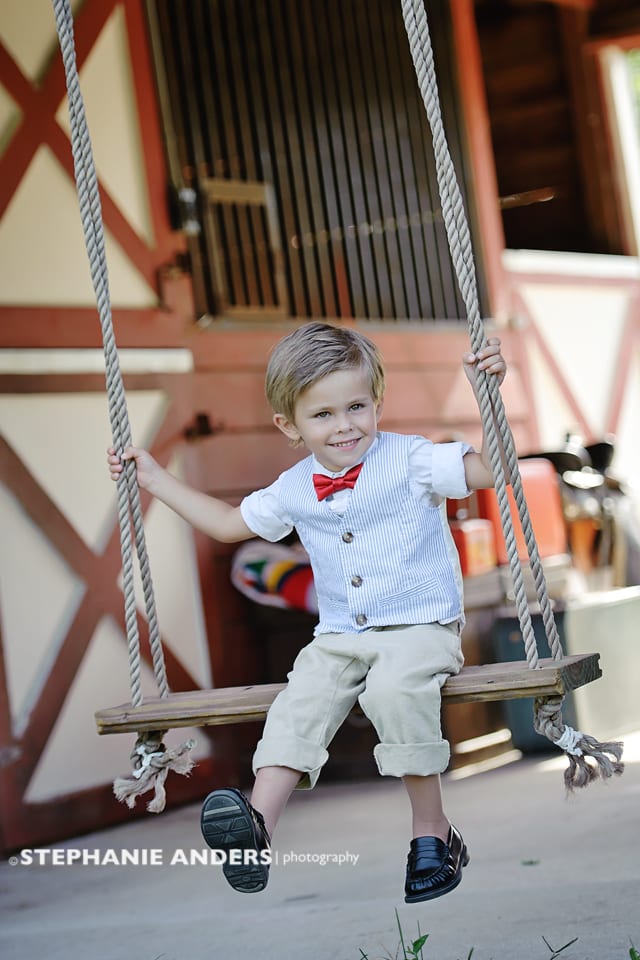 young boy on barn swing