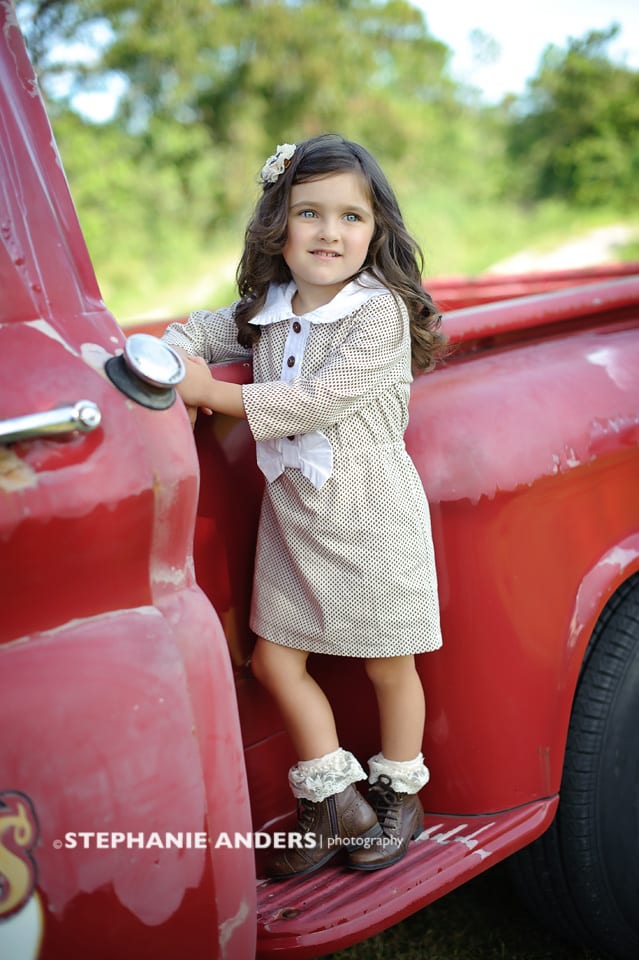 red truck with cute girl on side step
