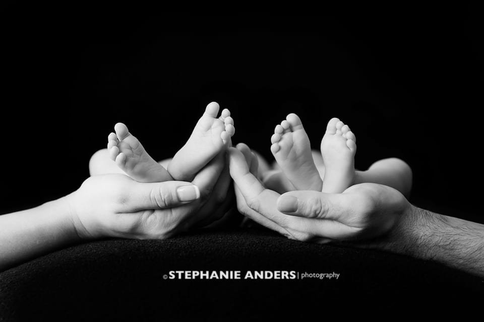 black and white photo of newborn feet only