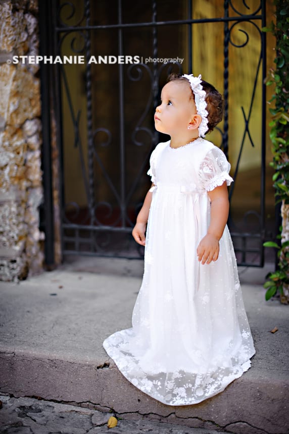 small child in white dress for baptism photos