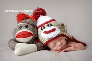 newborn with sock monkey