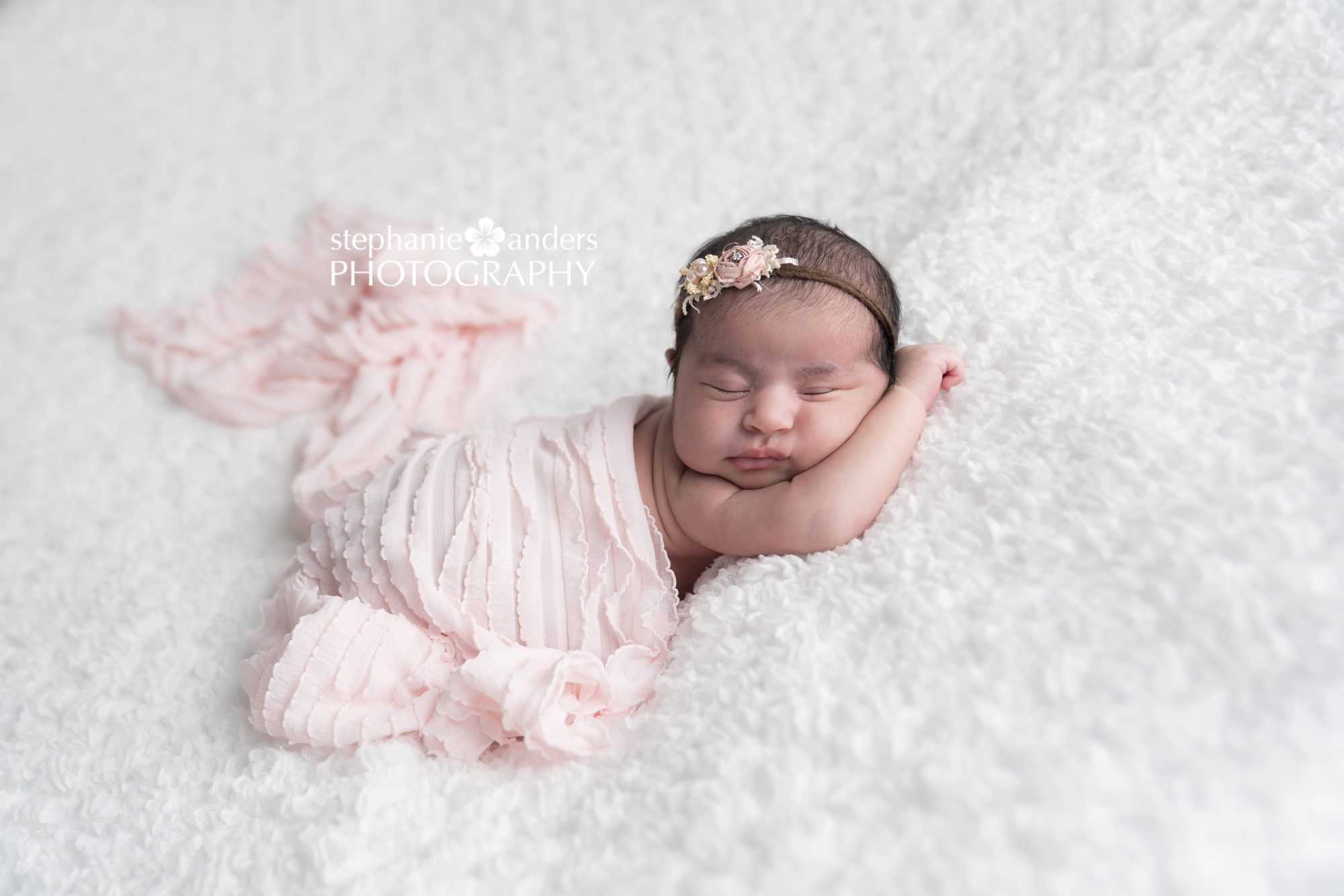 newborn baby with pink blanet
