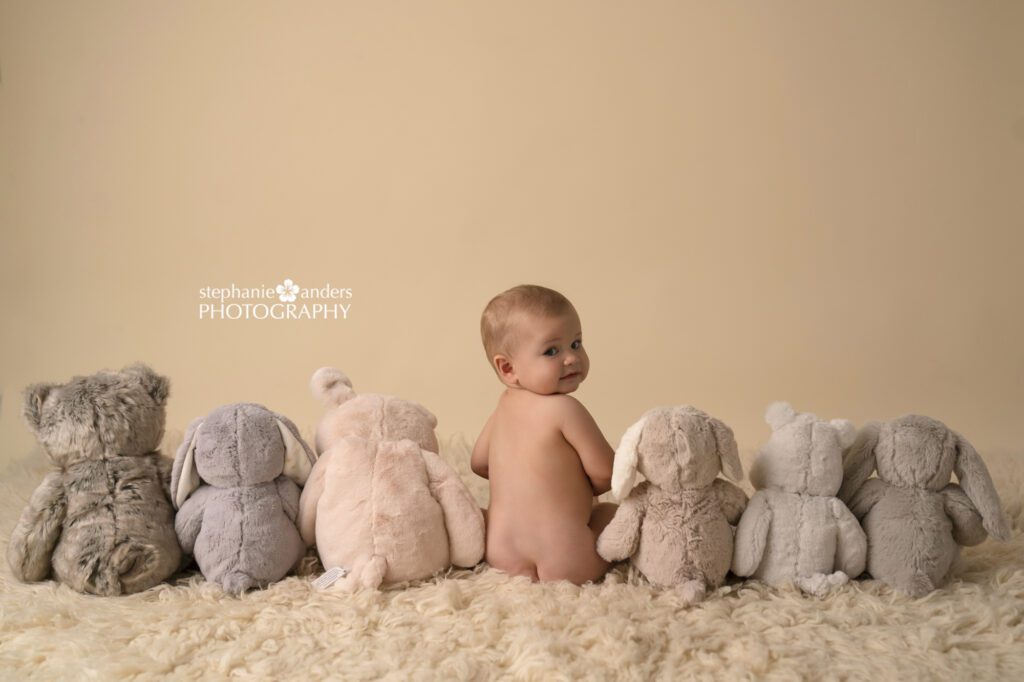 baby with stuffed animals