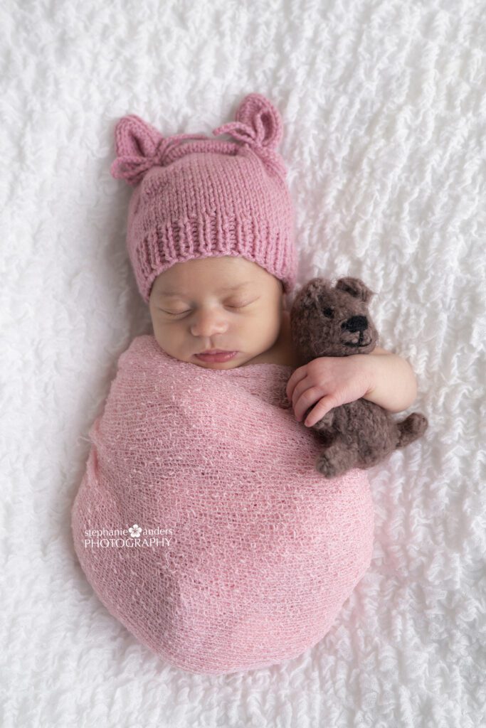 Newborn girl with brown teddy bear