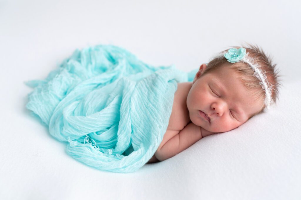newborn girl in turquoise