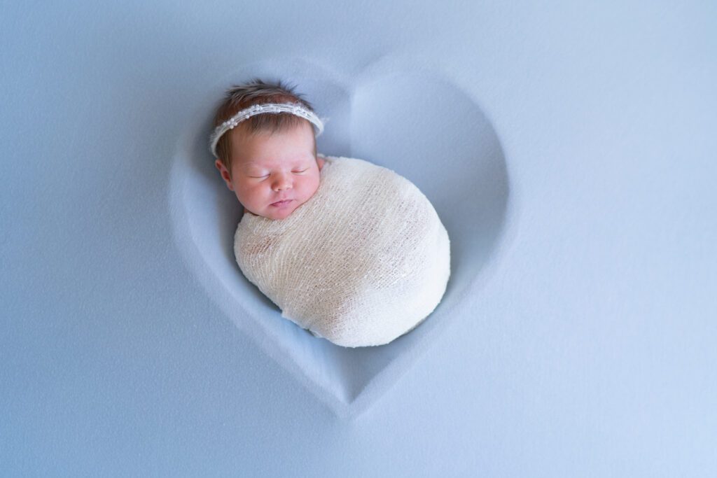 newborn girl in blue heart