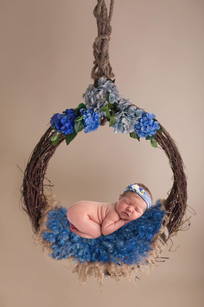 newborn girl in floral wreath