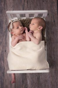 newborn twins in bed