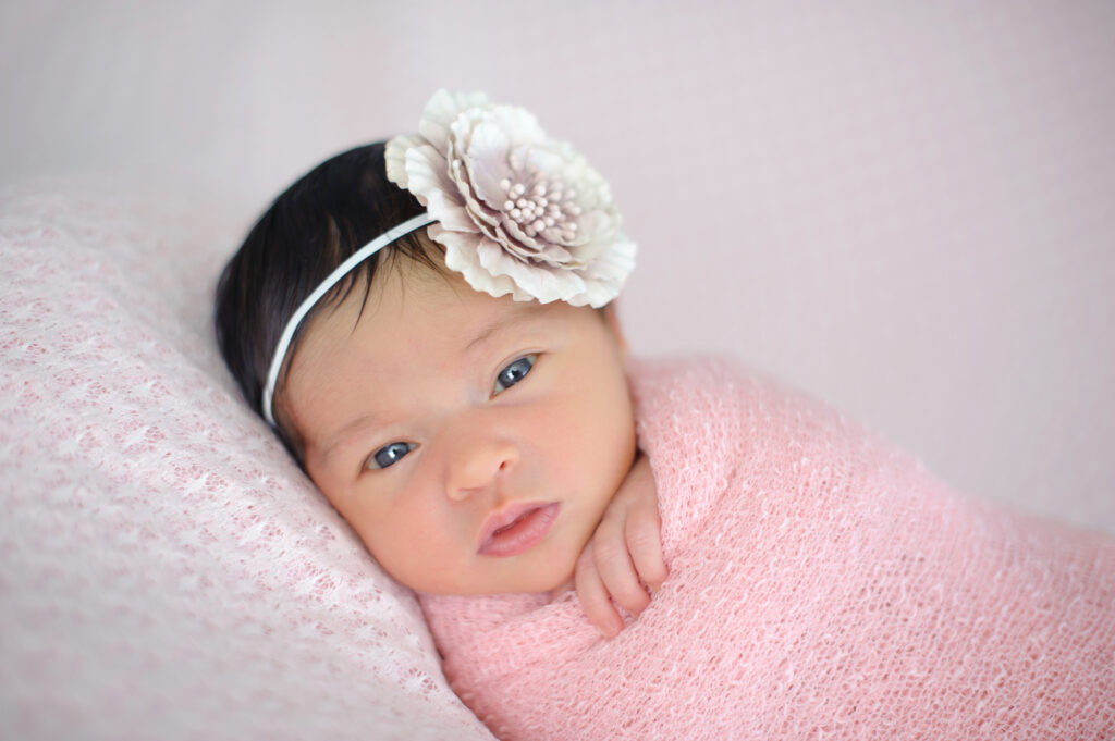 Awake newborn baby looking at the camera during a Miami newborn photography session.
