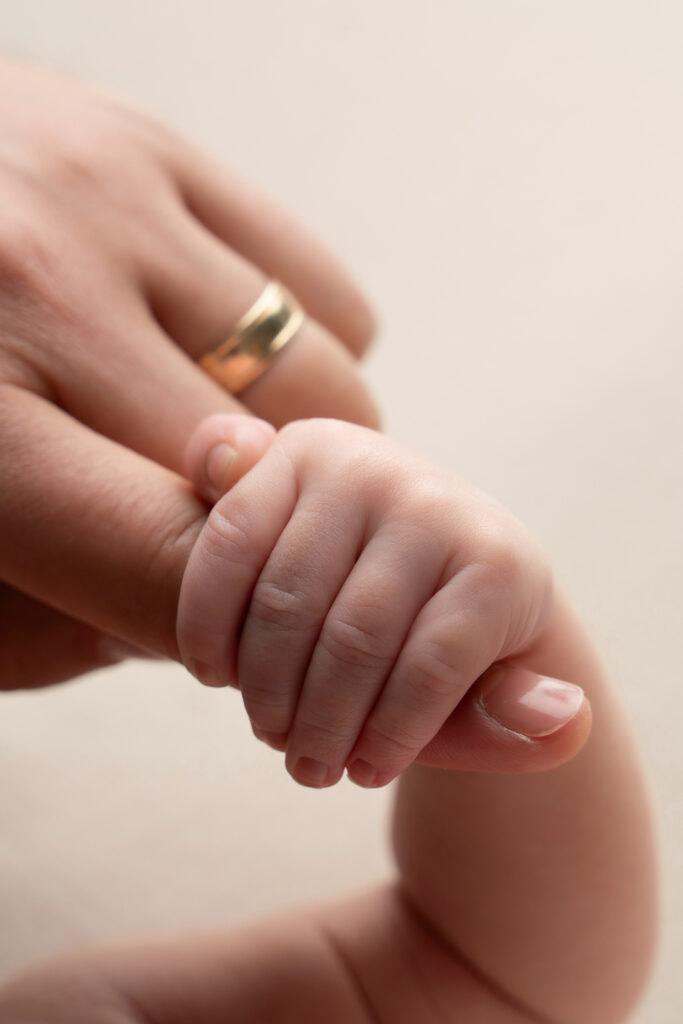 Close-up detail of a newborn baby’s tiny fingers during a Miami newborn photo session.