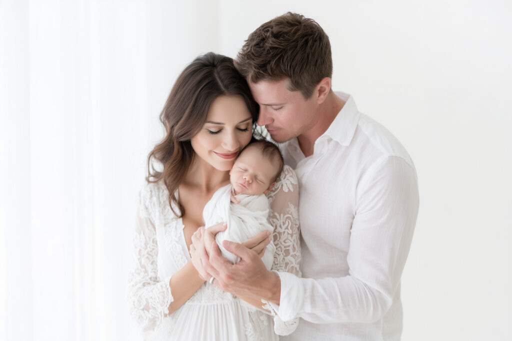 Parents wearing soft neutral clothing for their Miami newborn photo session.